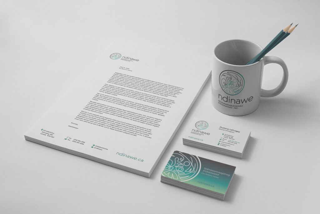 Ndinawe logo lockups on letterhead, a mug, and business cards