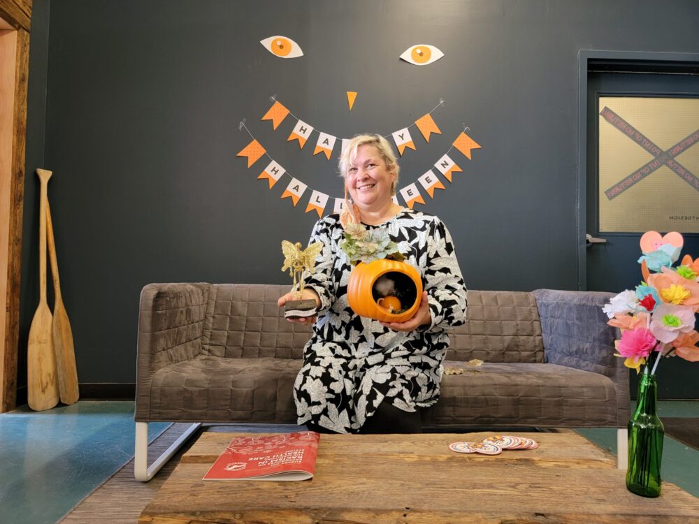 Claudine posing with pumpkin and trophy