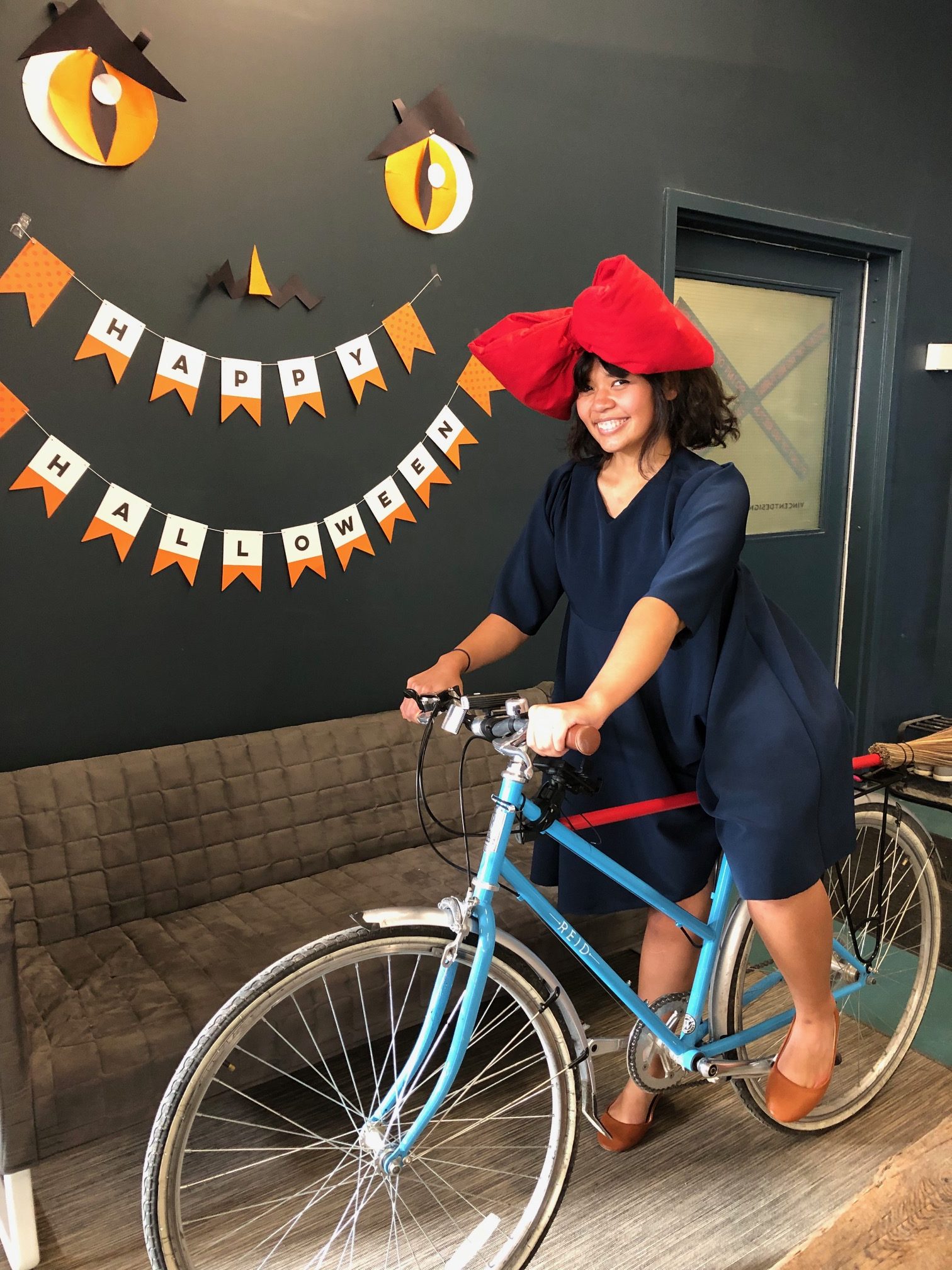 Arielle dressed up for Halloween sitting on bike