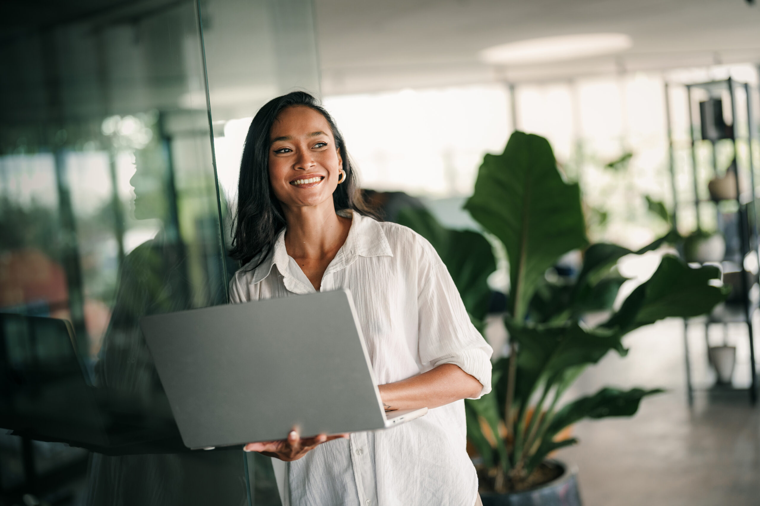 Woman smiling holding laptop