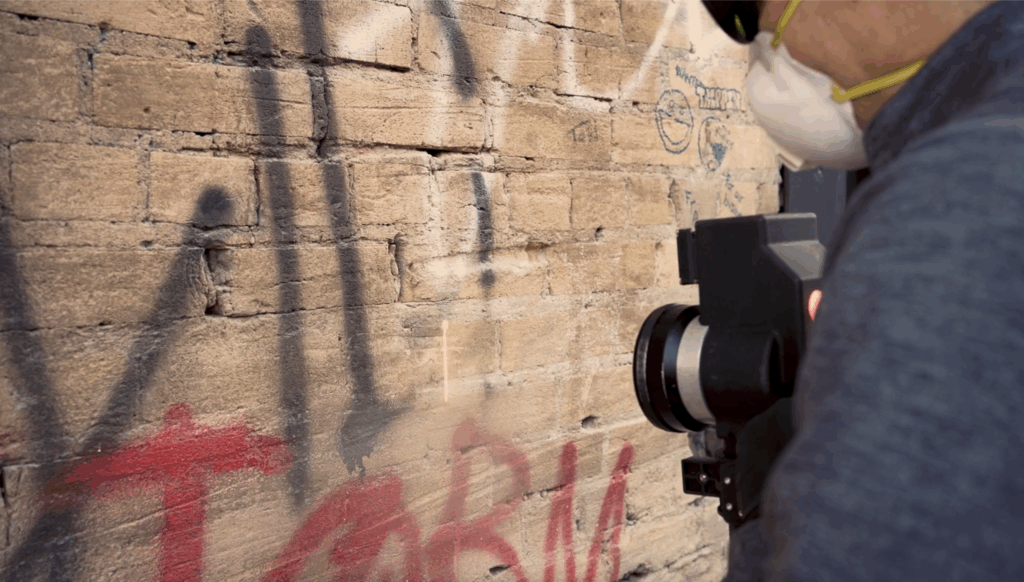 Advanced Environmental employee restoring building facade.