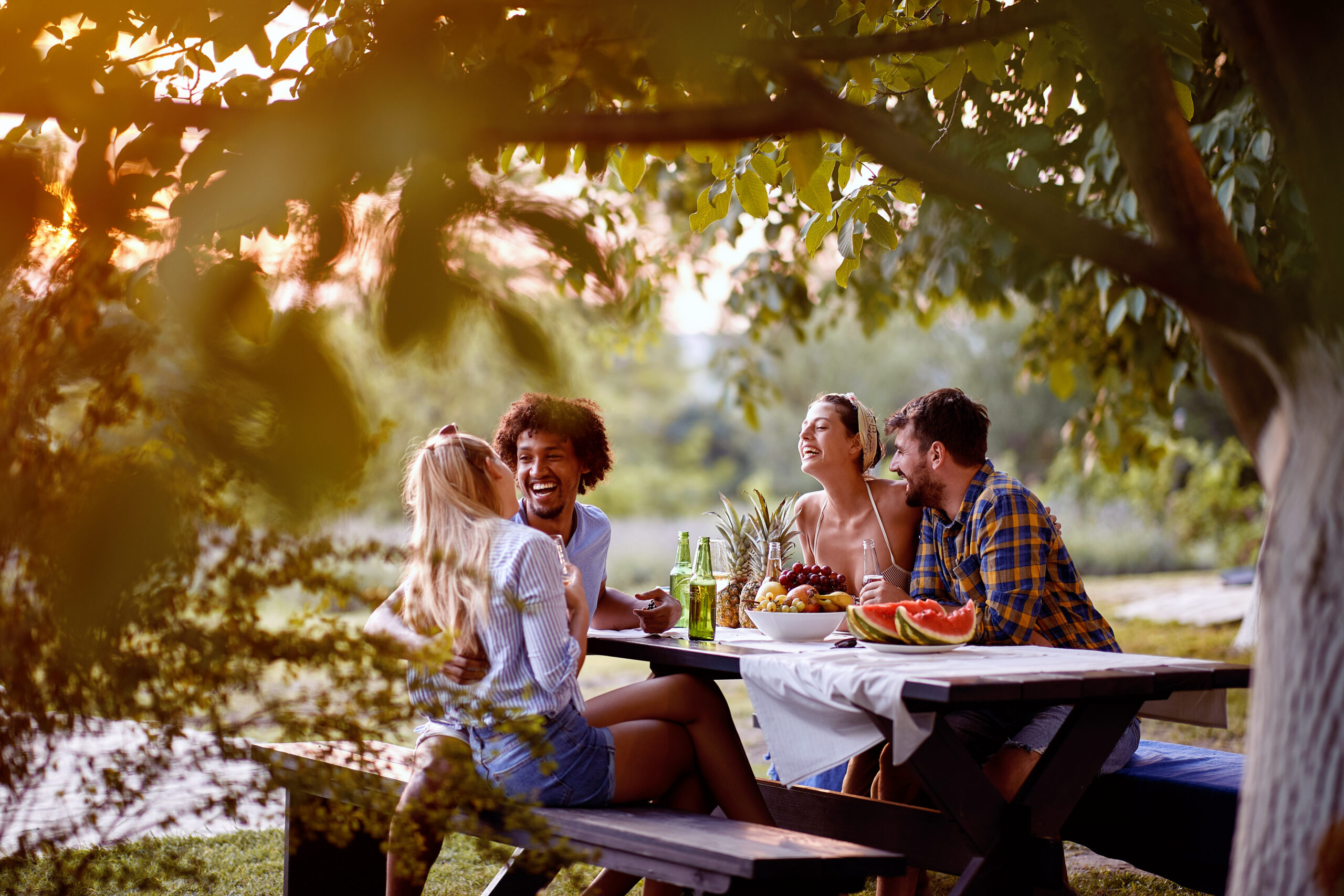 group of people in park at picnic table.